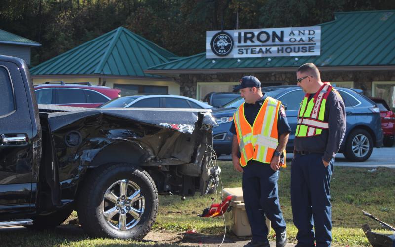 Megan Broome/The Clayton Tribune.Firefighter Hunter Hargrave, left,  and Assistant Fire Chief Justin Upchurch respond to the scene of a five-vehicle accident on Highway 441 at Bo James St. in Clayton on Monday.