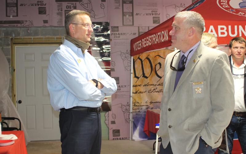 Megan Broome/The Clayton Tribune. Rep. Doug Collins talks with Sheriff Chad Nichols at a meet-and-greet held at the Rabun County Republican Party headquarters last Saturday. Collins is vying for a United States Senate seat and Nichols is running for reelection.