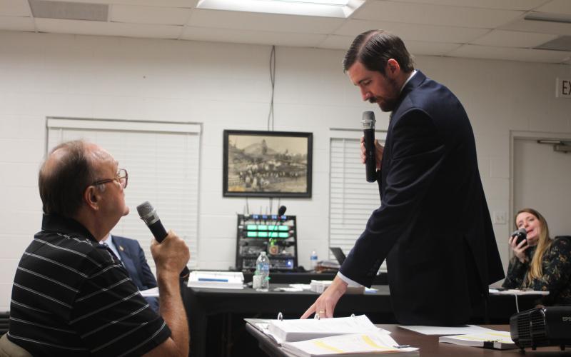 Megan Broome/The Clayton Tribune. David Irvin, left, is questioned by Tallulah Falls Town Attorney Warren Tillery at a hearing earlier this month to determine if J&amp;D Irvin Holdings has a vested right to operate their short-term vacation rental business after a zoning map change.