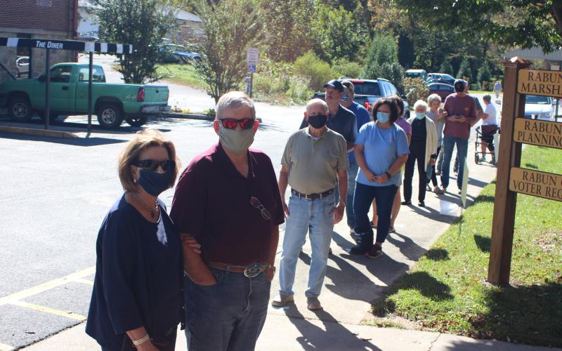 Megan Broome/The Clayton Tribune. Drucilla and Bob Graham (left) stand in a lengthy line at the Rabun County Board of Elections Office Monday to vote early.
