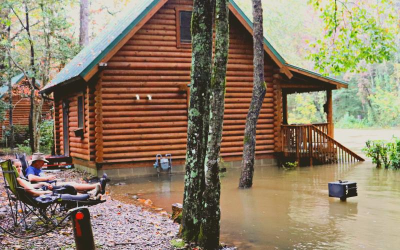 Submitted photo. Residents at a house on Old 441 in Lakemont relax and gaze at the flooding that occurred as a result of heavy storms from Hurricane Delta.