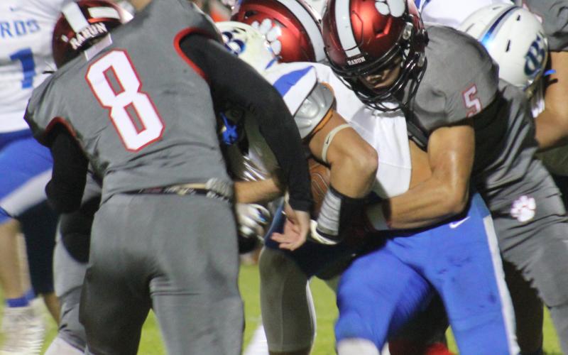 Andy Diffenderfer/The Clayton Tribune A Banks ballcarrier has nowhere to go as Hogan Woodard and Cory Keller combine on the tackle.