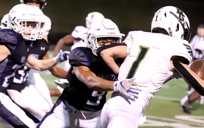 Photos courtesy of Rabun Gap-Nacoochee The Eagles’ Tucker Holloway tries to break free from Charlotte Christian tacklers.