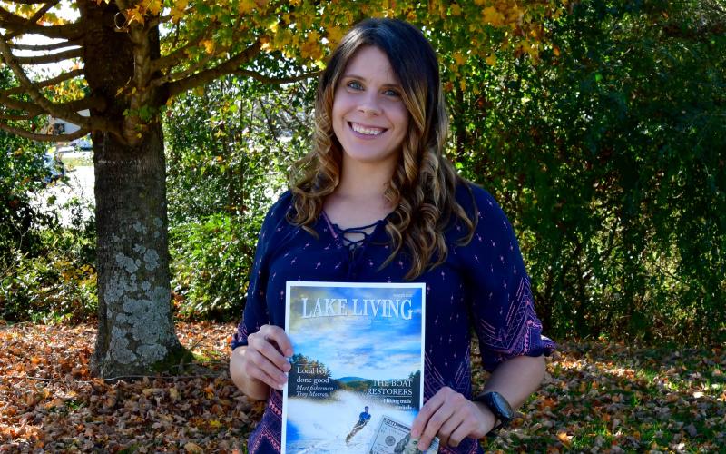 Photo courtesy Kimberly Brown. Heather Conner of Clayton holds a copy of her photograph of a water skier, which graces the cover of the winter 2020 edition of Lake Living magazine. In addition to having her photograph on the magazine's cover, Conner won $100.
