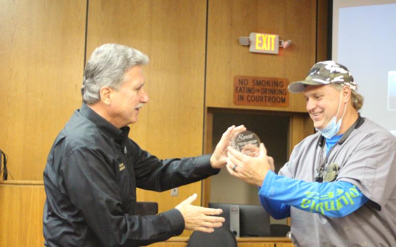 Megan Broome/The Clayton Tribune. Commission Chairman Gregg James, left, presents Commissioner Stephen Arbitter with an award to honor his 8 years of service to Rabun County. Last Tuesday was Arbitter’s last meeting before vacating his seat.