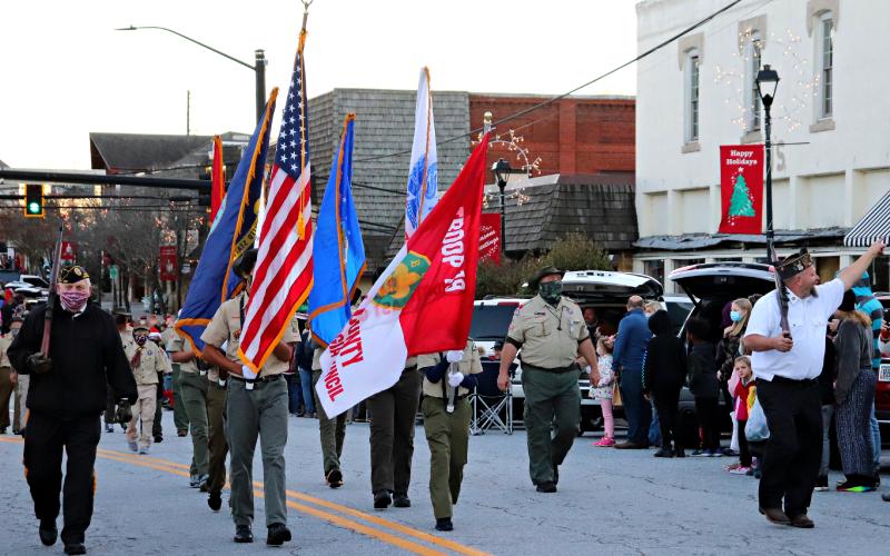 Photo courtesy Lisa Broz. Boy Scout Troop 19 served as honor guard for the parade escorted by two members of the American Legion. In addition to the colors they carried the flags of all the branches of the US military forces.