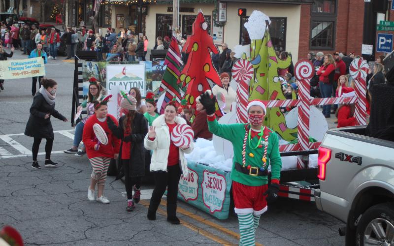 Megan Broome/The Clayton Tribune. Clayton First United Methodist Church was the second place winner in the judging contest for the Clayton Christmas Parade last Saturday with the theme “Jesus is the Sweetest Treat.” Pastor Zack Martin waves at bystanders as the float travels down Main Street.