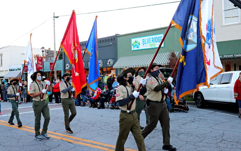 Photo courtesy Lisa Broz. Boy Scout Troop 19 served as honor guard for the parade escorted by two members of the American Legion. In addition to the colors they carried the flags of all the branches of the US military forces.