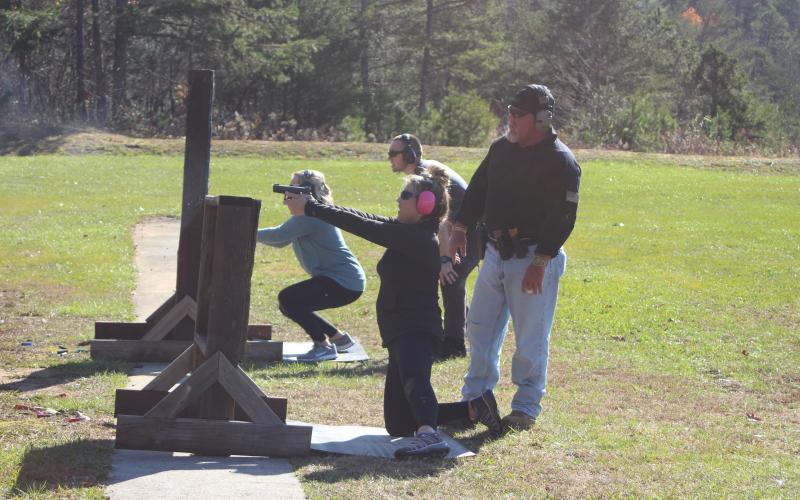 Megan Broome/The Clayton Tribune. Deputy Clinton Scott and Lt. Mark Gerrells assist attendees of the Level 3 Firearms Safety Course in moving and shooting training exercises at the sheriff’s office training center in Tiger.
