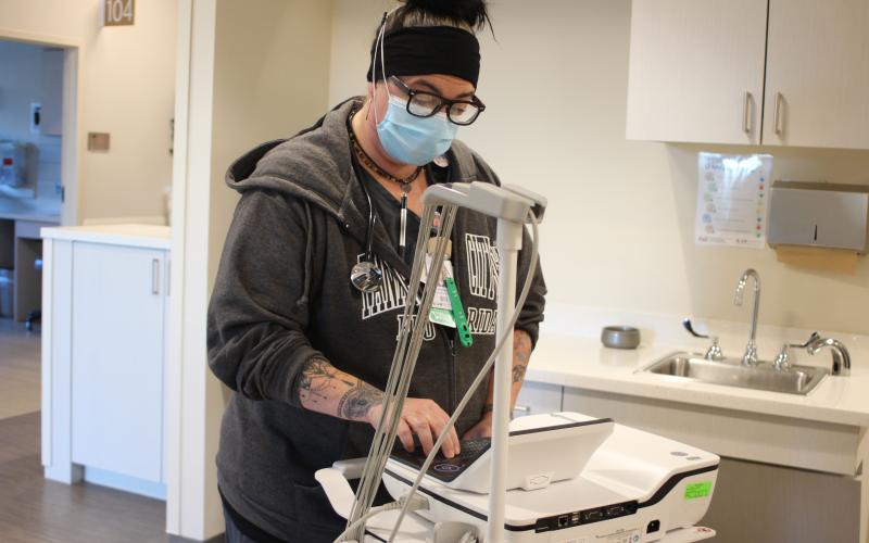 Megan Broome/The Clayton Tribune. Andrea Henry, respiratory therapist at MLMC, works with an EKG machine in the emergency department at Mountain Lakes Medical Center.