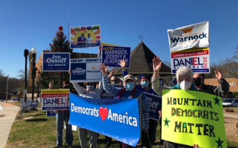 Submitted photo. The Rabun County and Habersham County Democratic parties hold a “flash mob” campaign event. The Rabun County Democrats travelled to neighboring counties to give out free Warnock and Ossoff signs ahead of the Jan. 5 runoff.