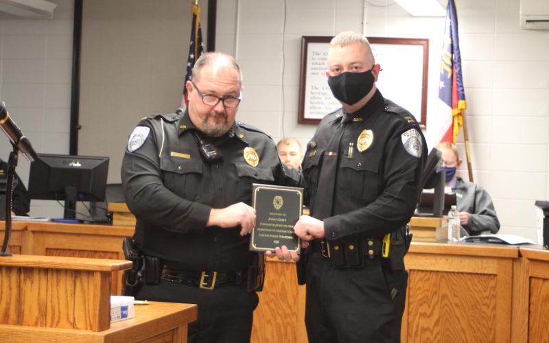 Megan Broome/The Clayton Tribune. Clayton Police Chief Andy Strait congratulates new Assistant Police Chief John Grist.