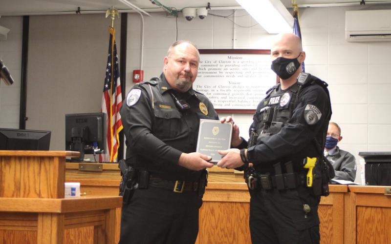 Megan Broome/The Clayton Tribune. Clayton Police Chief Andy Strait congratulates Supervisor of the Year Sgt. Michael Bennett.