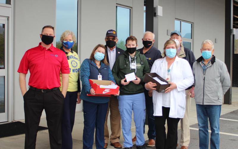 Megan Broome/The Clayton Tribune. The Rotary Club of Clayton distributed gift cards and thank you notes to front-line healthcare workers at Mountain Lakes Medical Center last week. Pictured are Rotarians Tony Penrose, Jane Janes, Alexis Luckett, RN, Rotary President Wayne Knuckles, Paramedic Cole O’Connor, Emergency Department, Rotary president-elect Jef Fincher, Rachel Cowart, Chief Nursing Officer, and Rotarians Matt Mitcham and Ray Pagano.