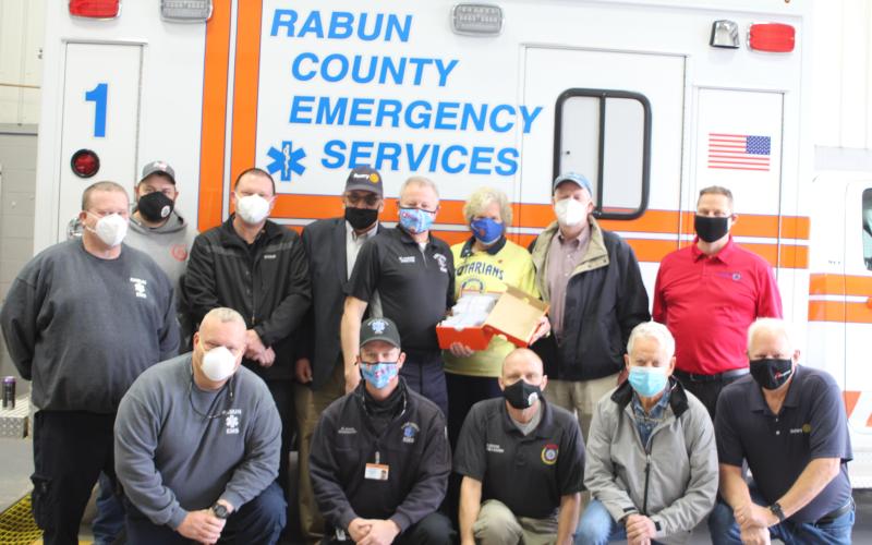 Megan Broome/The Clayton Tribune. David Lyle, paramedic, front left, David Jones, paramedic, Greg Dover, E-911, Ray Pagano, Rotarian, and Jef Fincher, Rotary president-elect.  Arne Triplett, back left, advanced EMT, Geoffrey Justus, E-911 supervisor, Captain Trampes Stancil, Wayne Knuckles, Rotary president, Mike Carnes, EMS/911 director, Jane Janes, Rotarian, Matt Mitcham, Rotary secretary, and Tony Penrose, Rotarian.