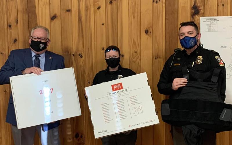 Submitted photo. Michael Palmer, president of North Georgia Mountains Lodge #112 of the Georgia State Fraternal Order of Police (FOP), left, presents Dillard Police Officer Victoria Hopper and Dillard Police Chief Jeremy Parker with ballistic vests from the FOPs “Protect the Protectors” program at last month’s Dillard City Council meeting.