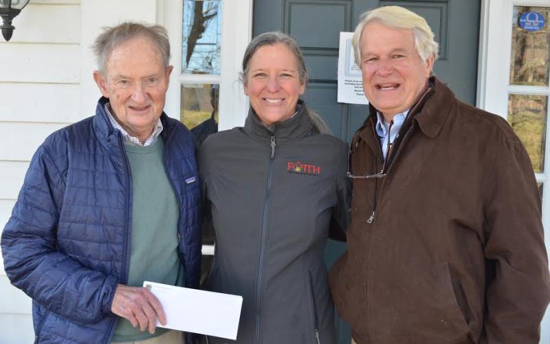 Wayne Knuckles/The Clayton Tribune. Lake Rabun Foundation Executive Director Steve Raeber, left, and Director Emertius Buz Stone, right, present a check for $10,000 to Fight Abuse in the Home (FAITH) Executive Director Caroline Wallis Monday. The contribution put the LRF's total giving to Rabun County at over $2 million.