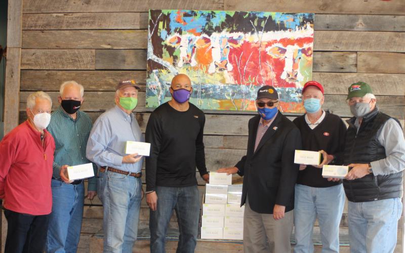 Megan Broome/The Clayton Tribune. Pictured are Rotarians Ray Pagano, Jef Fincher, Chip Goen, Food Bank Director James Brim, Rotary President Wayne Knuckles and Rotarians Matt Mitchum and David Tatum.