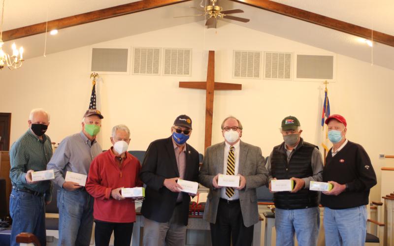 Megan Broome/The Clayton Tribune. Rabun Gap Presbyterian Church Pastor Don Barber (third from right) accepts a donation of face masks from The Rotary Club of Clayton members Jef Fincher, Chip Goen, Ray Pagano, Wayne Knuckles, David Tatum and Matt Mitchum Monday.