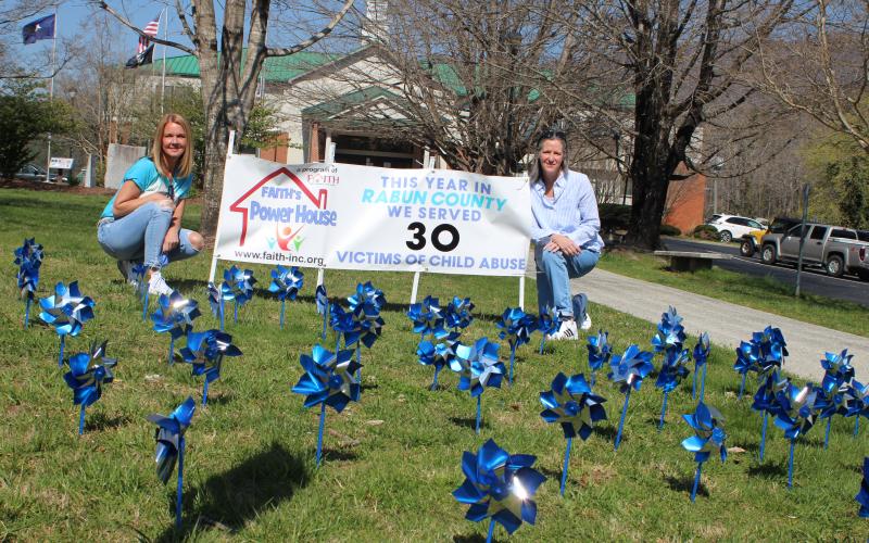 Megan Broome/The Clayton Tribune. Monica Blalock, director of community awareness for FAITH, left, and Caroline Wallis, executive director for FAITH, bring awareness of Sexual Assault and Child Abuse Prevention month with Pinwheels in front of the Rabun County Courthouse.