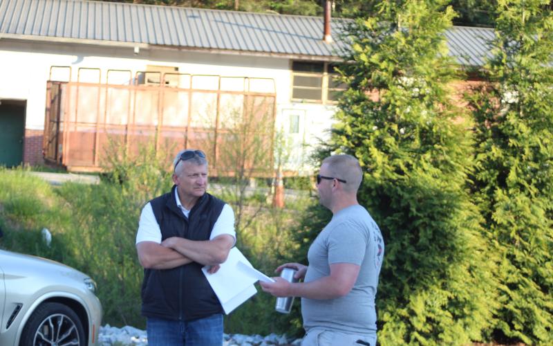 Megan Broome/The Clayton Tribune. County Administrator Darrin Giles and Clayton Mayor Jordan Green converse after a forum about water and sewer consolidation hosted by the RCC4GG on Monday.