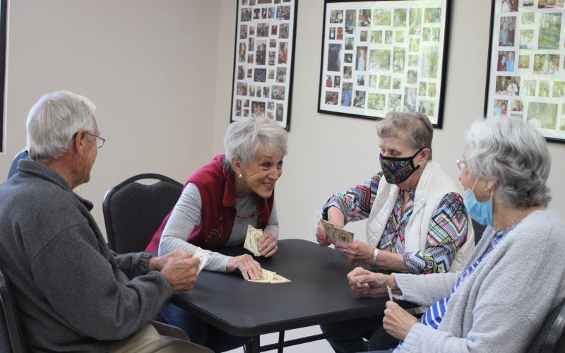 Megan Broome/The Clayton Tribune. Ronnie Balkcom, left, Nancy Phillips, Georgiann Wilson, and Peggy Thrasher play cards at the Rabun County Senior Center. The facility will open on Monday after being closed over a year due to the coronavirus pandemic.