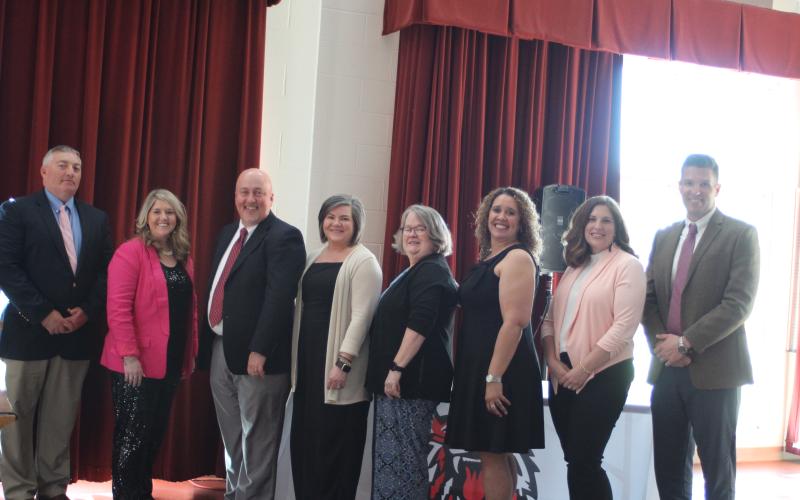 Megan Broome/The Clayton Tribune. Jonathan Welch, RCES Principal, left, Jaimie Crane, RCES and System Teacher of the Year, Jay Fowler, RCPS principal, Lynn Talley, RCPS Teacher of the Year, Kaye Collins, RCMS Teacher of the Year, Kechara Partin, RCMS principal, Alicia McCracken, RCHS Teacher of the Year, and Justin Spillers, RCHS principal, attend a banquet honoring the teachers of the year on April 15.