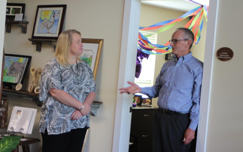 Megan Broome/The Clayton Tribune. Rabun County Chamber of Commerce board Treasurer Nicole Queen, left, converses with new chamber President Cliff Bussard at a meet-and-greet held at the Rabun County Welcome Center on Monday. Monday was Bussard's first day and community members got the opportunity to meet Bussard and converse with him one-on-one.