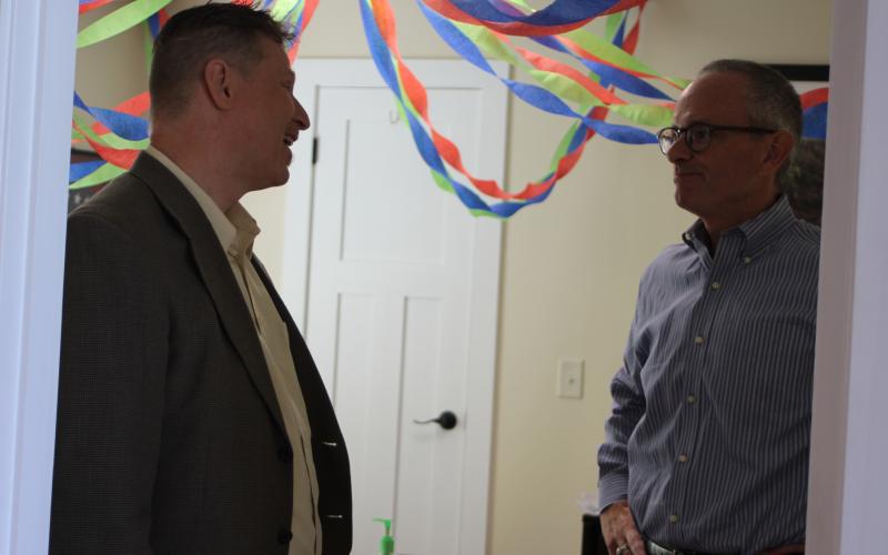 Megan Broome/The Clayton Tribune. Chamber of Commerce board member Tony Penrose, left, converses with new chamber President Cliff Bussard at a meet-and-greet event held at the Rabun County Welcome Center on Monday.