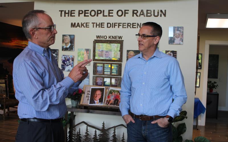 Megan Broome/The Clayton Tribune. Clayton City Manager Michael Esposito, right, converses with  new chamber President Cliff Bussard at a meet-and-greet event held at the Rabun County Welcome Center on Monday.