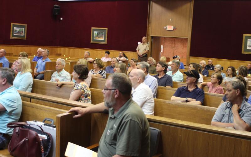 Megan Broome/The Clayton Tribune. A crowd of people from Lake Burton and other parts of Rabun County attended Tuesday’s Board of Commissioners meeting and spoke passionately for or against the agenda item to rezone the property at 8118 Bridge Creek Rd. from Agricultural to Commercial Business.