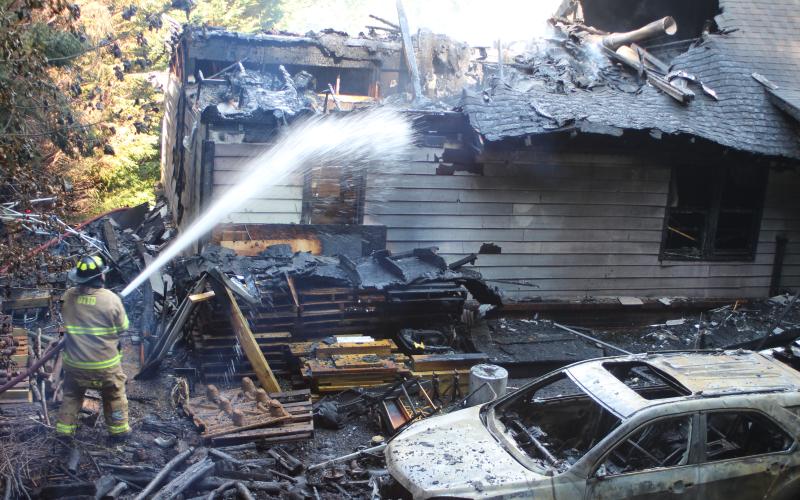 Megan Broome/The Clayton Tribune. Firefighters battle a blaze in the Vista Ridge Apartment Complex on Sunday.