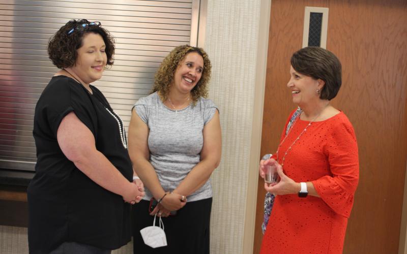 Megan Broome/The Clayton Tribune. Amy Pruitt, federal programs director, left, Kechara Partin, RCMS principal, and Cindi Dean, director of business business operations and human resources, attend the 2020-2021 retired employee reception held at RCHS last Thursday.