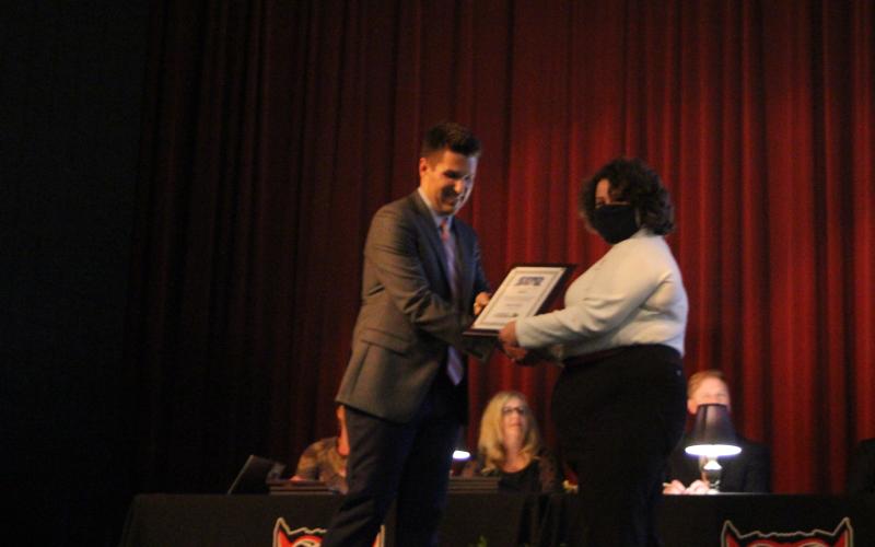 Megan Broome/The Clayton Tribune. RCHS Principal Justin Spillers, left, presents Abigail Page with an award in the auditorium of the Fine Arts Building on Senior Scholarship and Awards Night held on  May 11.