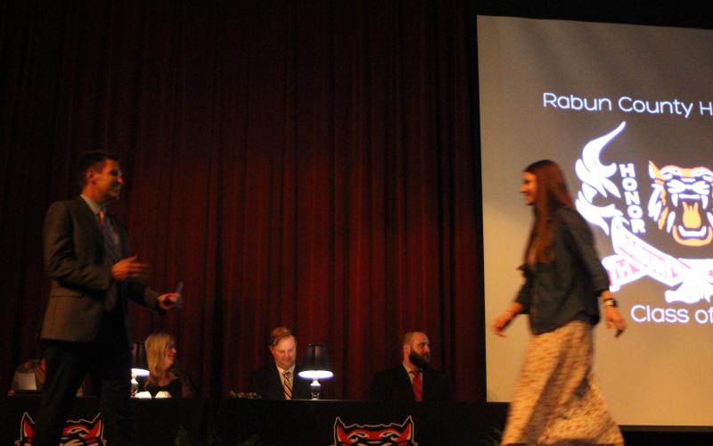 Megan Broome/The Clayton Tribune. RCHS Class of 2021 graduate Sophie Raby receives a scholarship on Senior Scholarship and Awards Night presented by RCHS Principal Justin Spillers. The event was held in the RCHS Fine Arts Building on May 11.