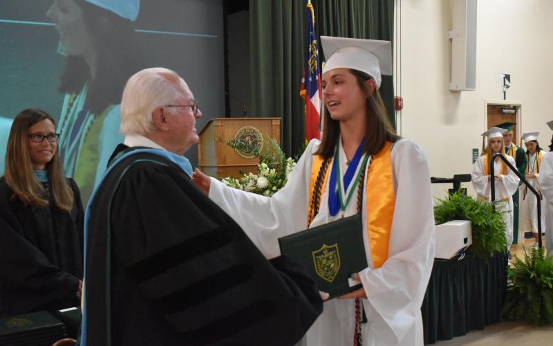 Photo courtesy Brian Wellmeier/CNI Regional Newspapers. Tallulah Falls President and Head of School Larry Peevy converses with graduate Maggie Jackson at the Class of 2021 graduation this past weekend.
