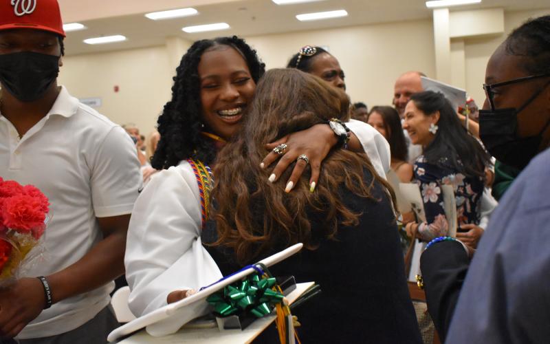 Photo courtesy Brian Wellmeier/CNI Regional Newspapers. Graduate Fendi Jean-Louis is hugged by friends and family members at the Tallulah Falls Class of 2021 graduation this past weekend.