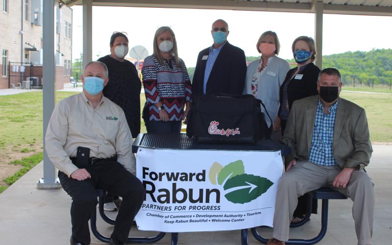 Megan Broome/The Clayton Tribune. Rick Story, director of development for Rabun County, Keri Coleman, assistant principal of Rabun County Primary School, April Childers, superintendent for Rabun County Schools, Brent Edward's, area manager for Georgia Power, Misty Houston, Rabun County Bank, Nicole Dover, director of strategy and communication at Habersham EMC, and Claude Dillard, vice president of Rabun County Bank, distribute lunches at RCPS last Thursday for Teacher Appreciation Week.