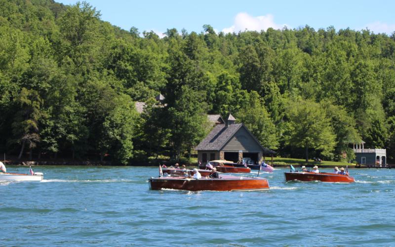 Megan Broome/The Clayton Tribune. Approximately 27 boats participated in the annual Lake Burton Wooden Boat Parade on Sunday. The boats set sail from Timpson Cove led by the Rabun County Fire Services Fire Boat and made their way to LaPrade’s Marina where members of the public were invited to view the boats.