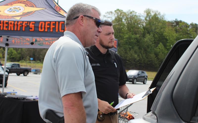 Megan Broome/The Clayton Tribune. Rabun County Sheriff Chad Nichols, left, and Dillard Police Chief Jeremy Parker participated in a car seat inspection event at the Clayton Walmart where nationally certified technicians helped citizens properly install car seats and booster seats. The RCSO partnered with Safe Kids Rabun County for the event.