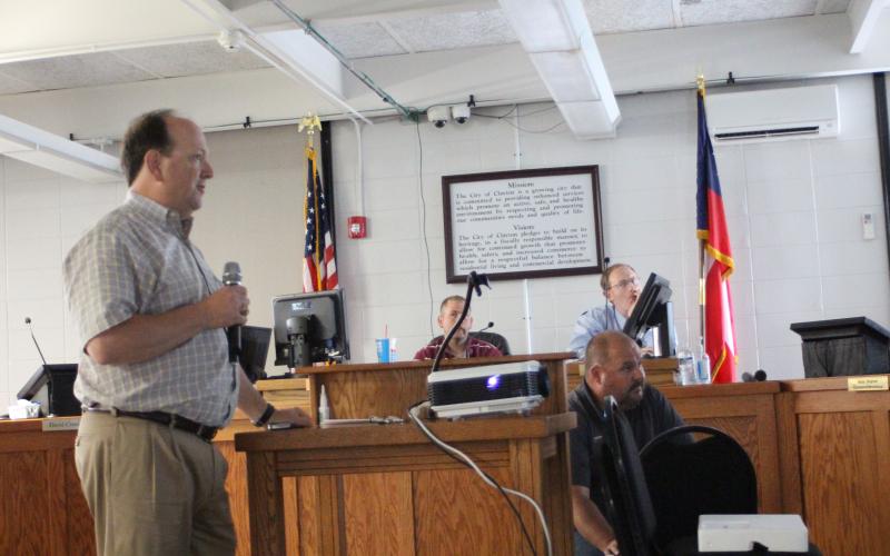 Megan Broome/The Clayton Tribune. Eric Neese, engineer for the city of Clayton, gives a presentation to Clayton council members at Tuesday’s meeting to discuss discrepancies in the billing cycle when the RCWSA billed the city twice in their April water bill. The city initially received an April bill of $85,000 and shortly after received a bill for April for an additional $26,000.