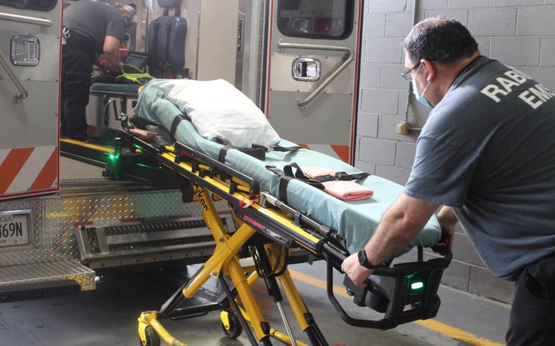 Megan Broome/The Clayton Tribune. Rabun County EMS paramedic Don White demonstrates how to use the new Stryker Power Load lift system on an ambulance. It’s an automated hydraulic lifting system that lifts patients who are on stretchers into and out of ambulances.