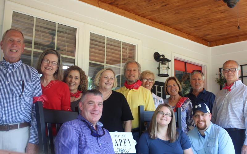 Megan Broome/The Clayton Tribune. Allison McFalls and Daniel Nicholson are the recipients of the Habitat for Humanity of Rabun County 2020 Habitat Home. Front row: Sheriff Chad Nichols, left, Allison McFalls and Daniel Nicholson. Back row: Ed Steil, chair of Building Committee, left, Barbara Anderson, Chair of Fundraising, Jeanine Marlow, Chair of Technology, Susan Smith, Steve Weintraub, Pat Steuck, past president, Cynthia Pagano, Tim Ranney, Chair of Finance, and Don Martin, president.