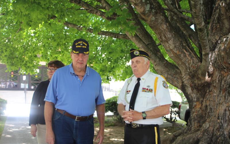 Megan Broome/The Clayton Tribune. Fred Remen, left, served as a Captain in the United States Coast Guard. He attended Monday’s Memorial Day ceremony. He speaks to Doug Wayne, S.V. Cdr. Chapter 15, master of ceremonies.