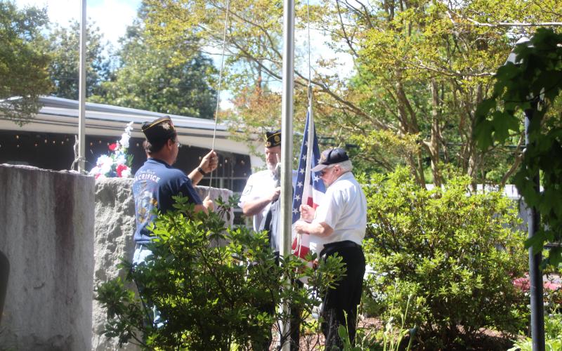 Megan Broome/The Clayton Tribune. Carl Green, Cdr American Legion Post 220 and Adam Swiencicki, VFW Post 4570, raised the flag and then lowered it to half mast at the Memorial Day ceremony held at the Rabun County Courthouse on Monday.