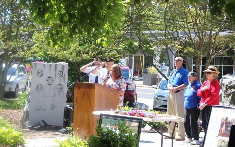 Megan Broome/The Clayton Tribune. Lauren Burrell sings the National Anthem at Monday’s Memorial Day ceremony to honor veterans who have passed away.