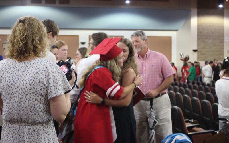 Megan Broome/The Clayton Tribune. Class of 2021 Valedictorian Lauren Barnes cries with tears of joy as she hugs her friend after receiving her diploma at last Friday’s graduation ceremony.