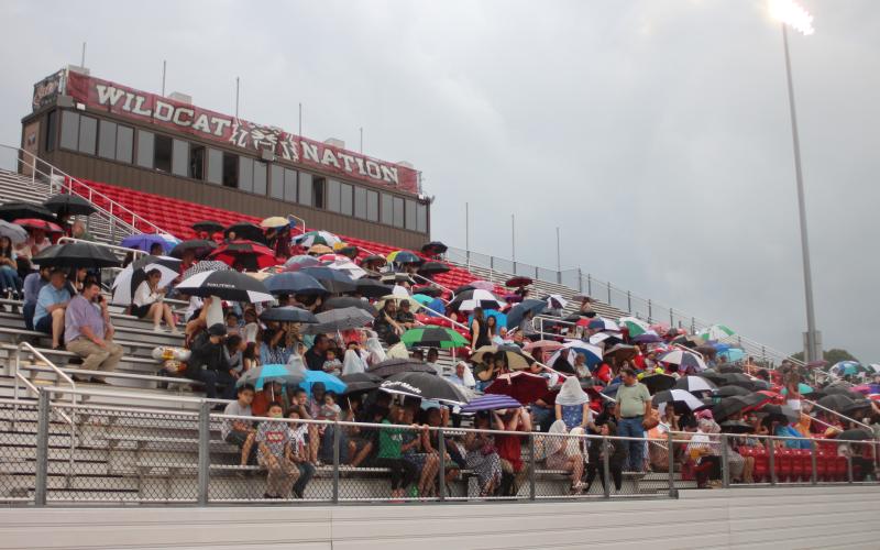 Megan Broome/The Clayton Tribune. Friends and family members of graduates brave the wind and rain to watch the Class of 2021 graduate. The ceremony had to be moved inside shortly after due to rain and threats of lightning strikes in the area.