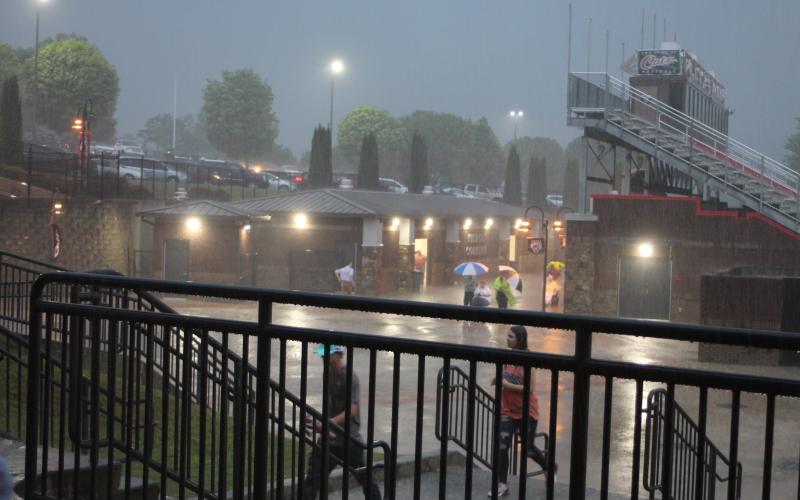 Megan Broome/The Clayton Tribune. Friends and family members of graduates brave the wind and rain to watch the Class of 2021 graduate. The ceremony had to be moved inside shortly after due to rain and threats of lightning strikes in the area.