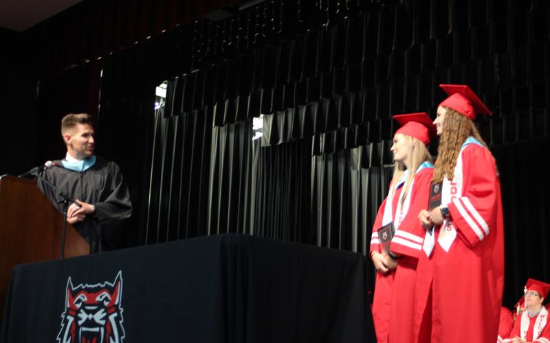Megan Broome/The Clayton Tribune. RCHS Principal Justin Spillers announces Sophie Raby and Natalie Nix as the recipients of the 2021 Wildcat Pride Award at last Friday’s graduation ceremony for the Class of 2021. Spillers said that these students are role models as leaders, and for their character, excellence in the classroom, service to others and service to the greater good. Each student also received a $500 scholarship.